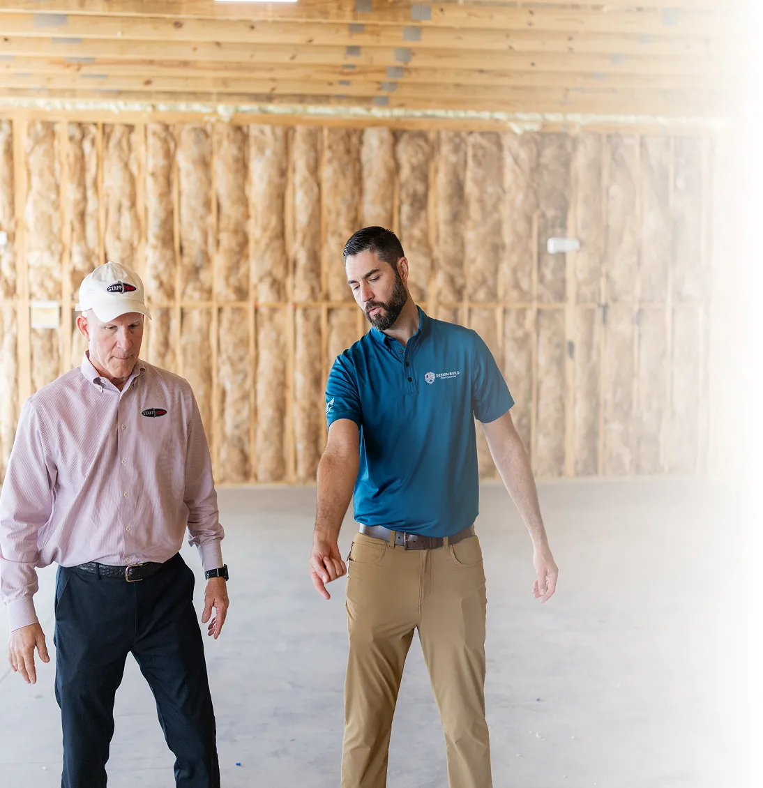 Design Build Construction owner walking a client through a building under construction
