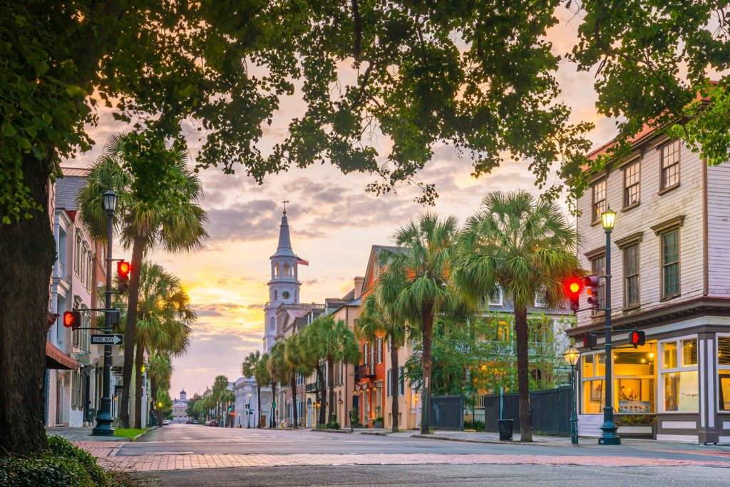 Historic storefronts and St. Michael's Church steeple in downtown Charleston, SC